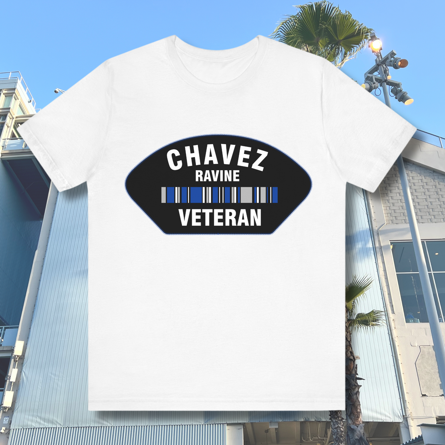 White Chavez Ravine Veteran t-shirt with black badge and blue stripe graphic — Dodgers-inspired Los Angeles baseball tee for fans.