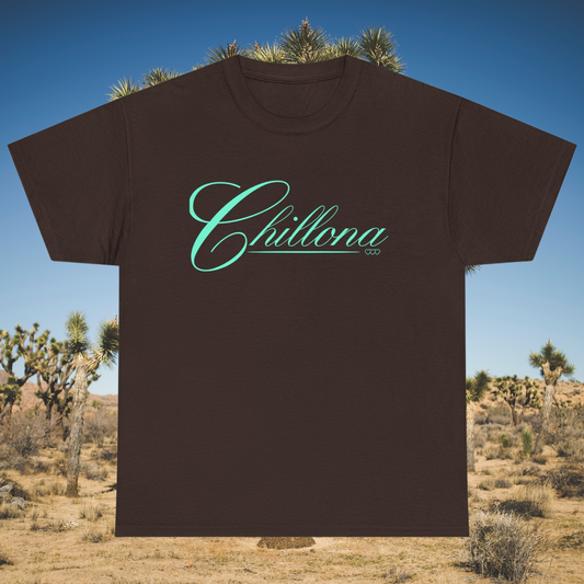 Brown t-shirt with mint green script reading “Chillona” in front of desert landscape


