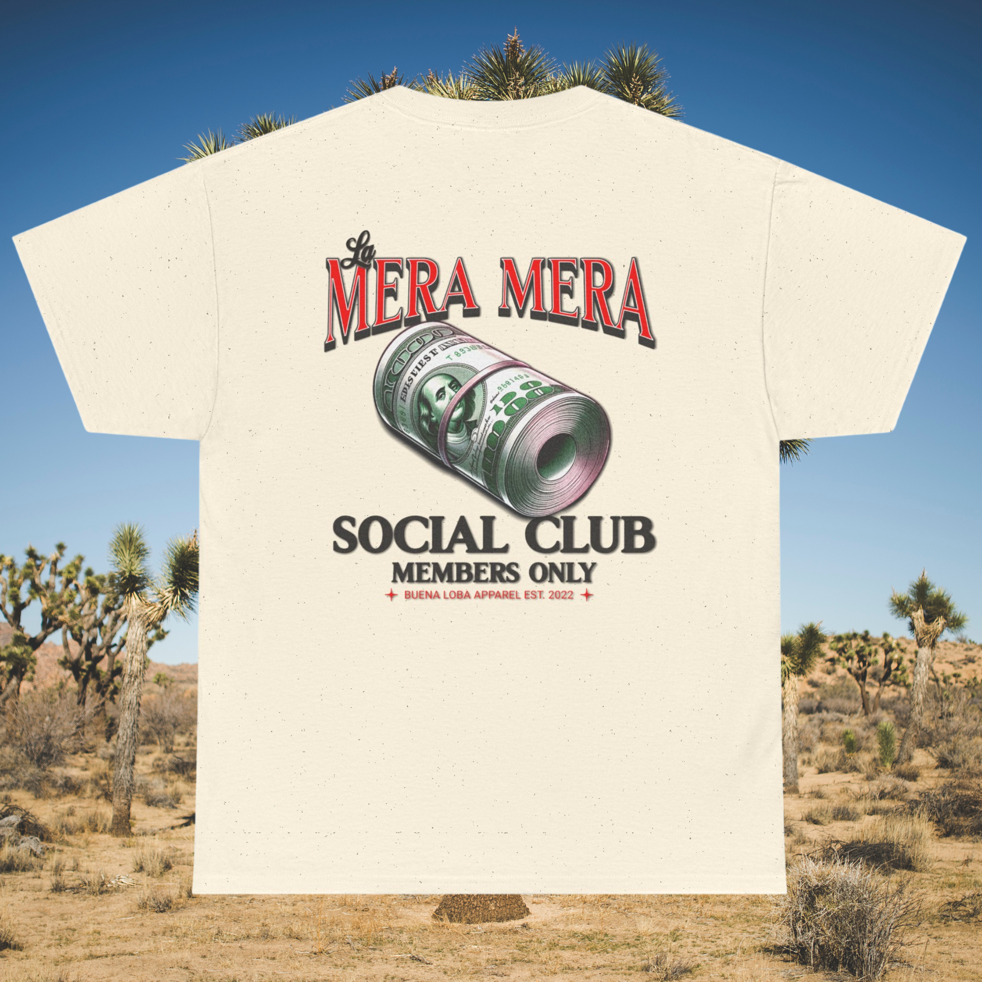 Cream t-shirt with “La Mera Mera Social Club” and dollar roll illustration in desert setting